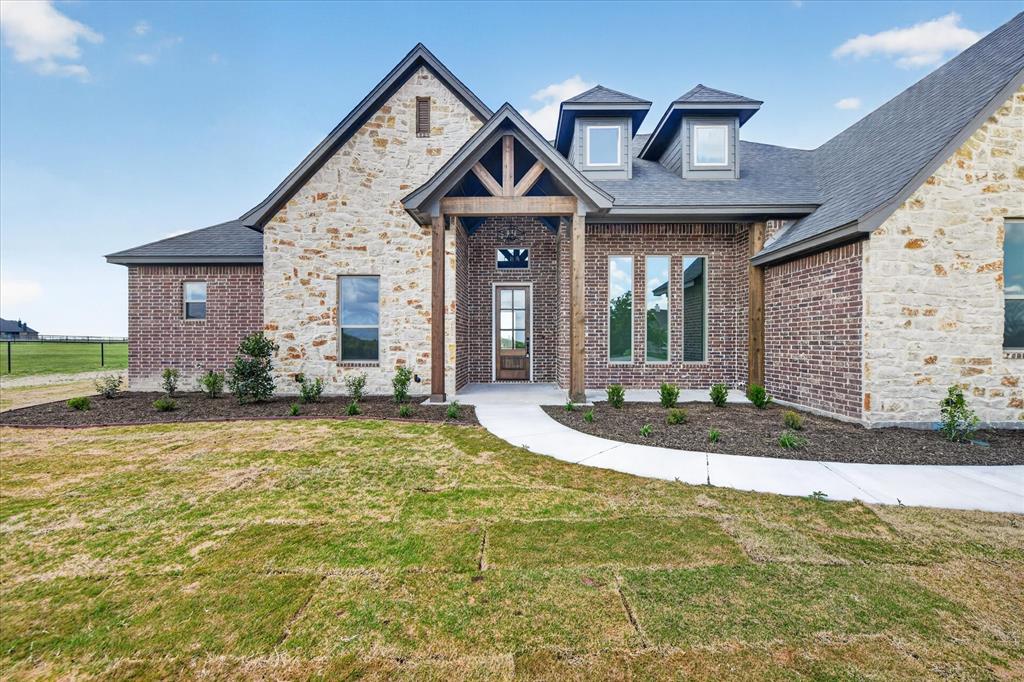 517 Longhorn Lane Springtown, TX 76082 - Photo 4 of 39 View of front of home featuring a front lawn, stone siding, brick siding, and roof with shingles
