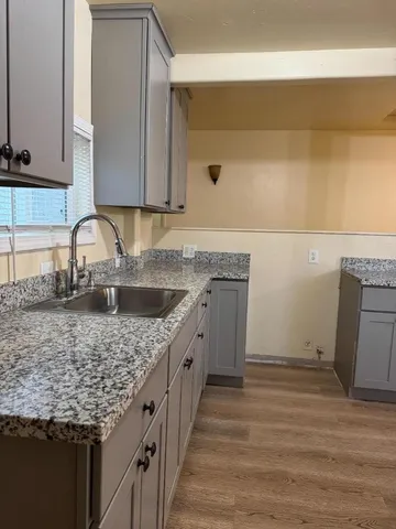 a kitchen with a sink stove and cabinets