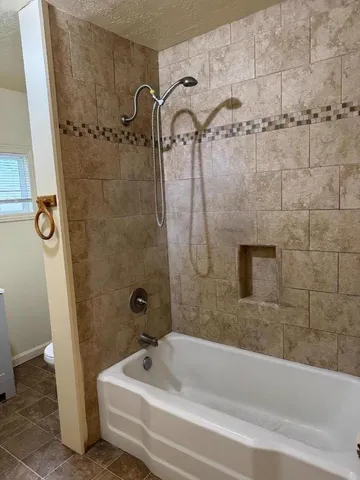 a bathroom with a bathtub and a shower
