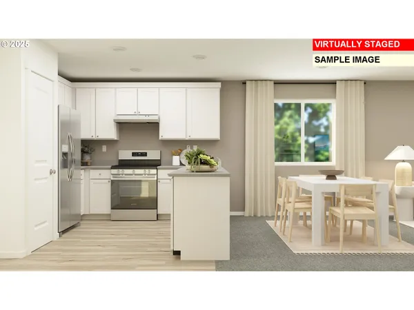 a kitchen with stainless steel appliances kitchen island granite countertop a table chairs in it and a window