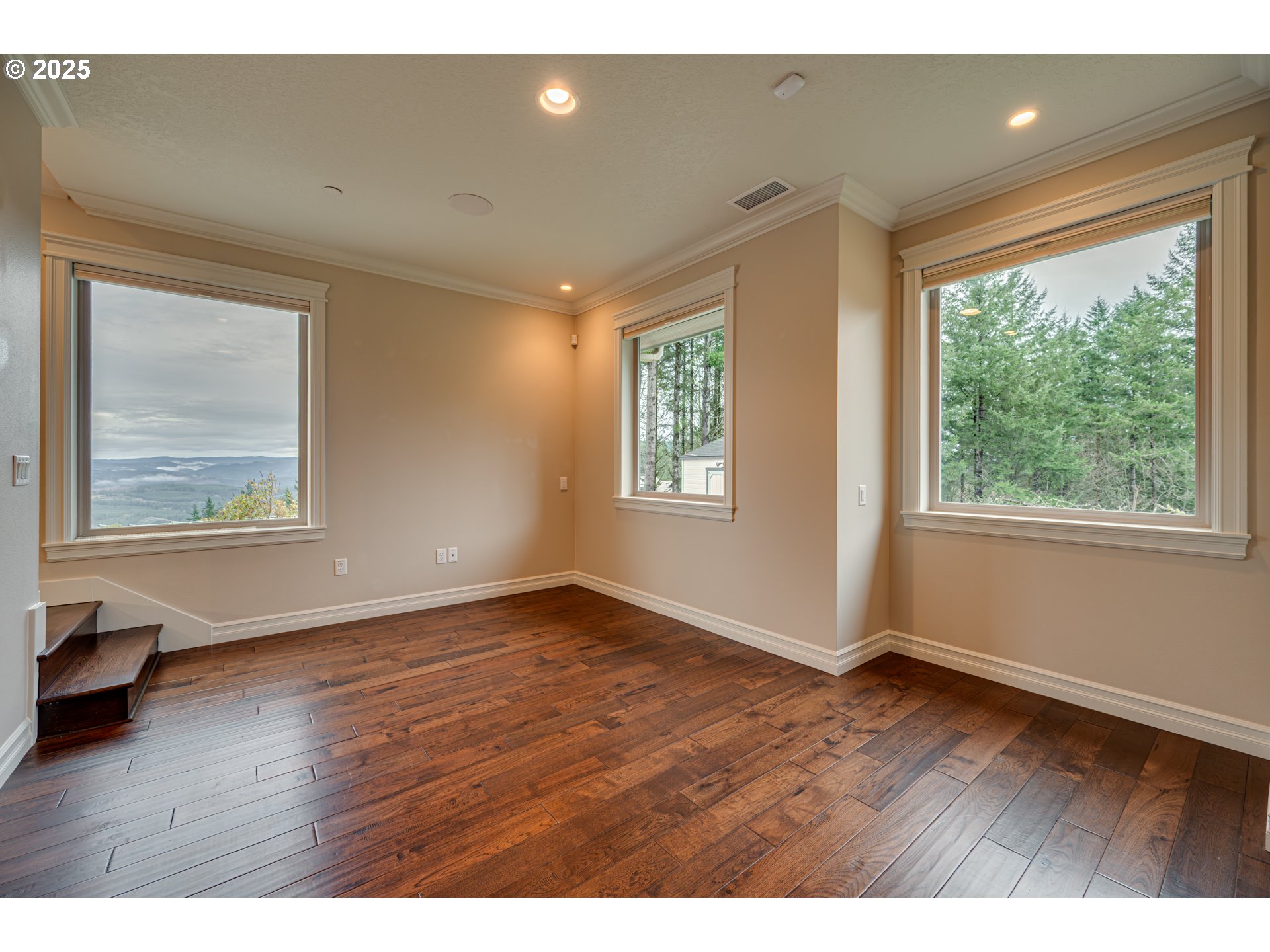 421 Woodland Heights Road Woodland, WA 98674 - Photo 18 of 48 an empty room with wooden floor and windows