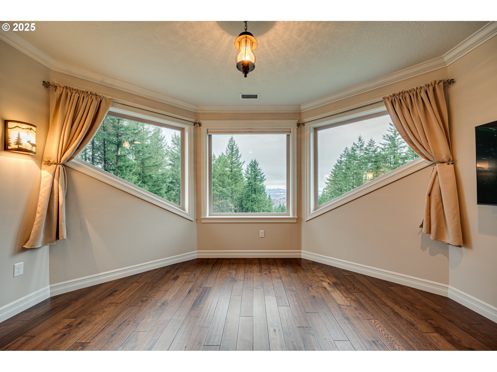 421 Woodland Heights Road Woodland, WA 98674 - Photo 19 of 48 a view of an empty room with wooden floor and a window