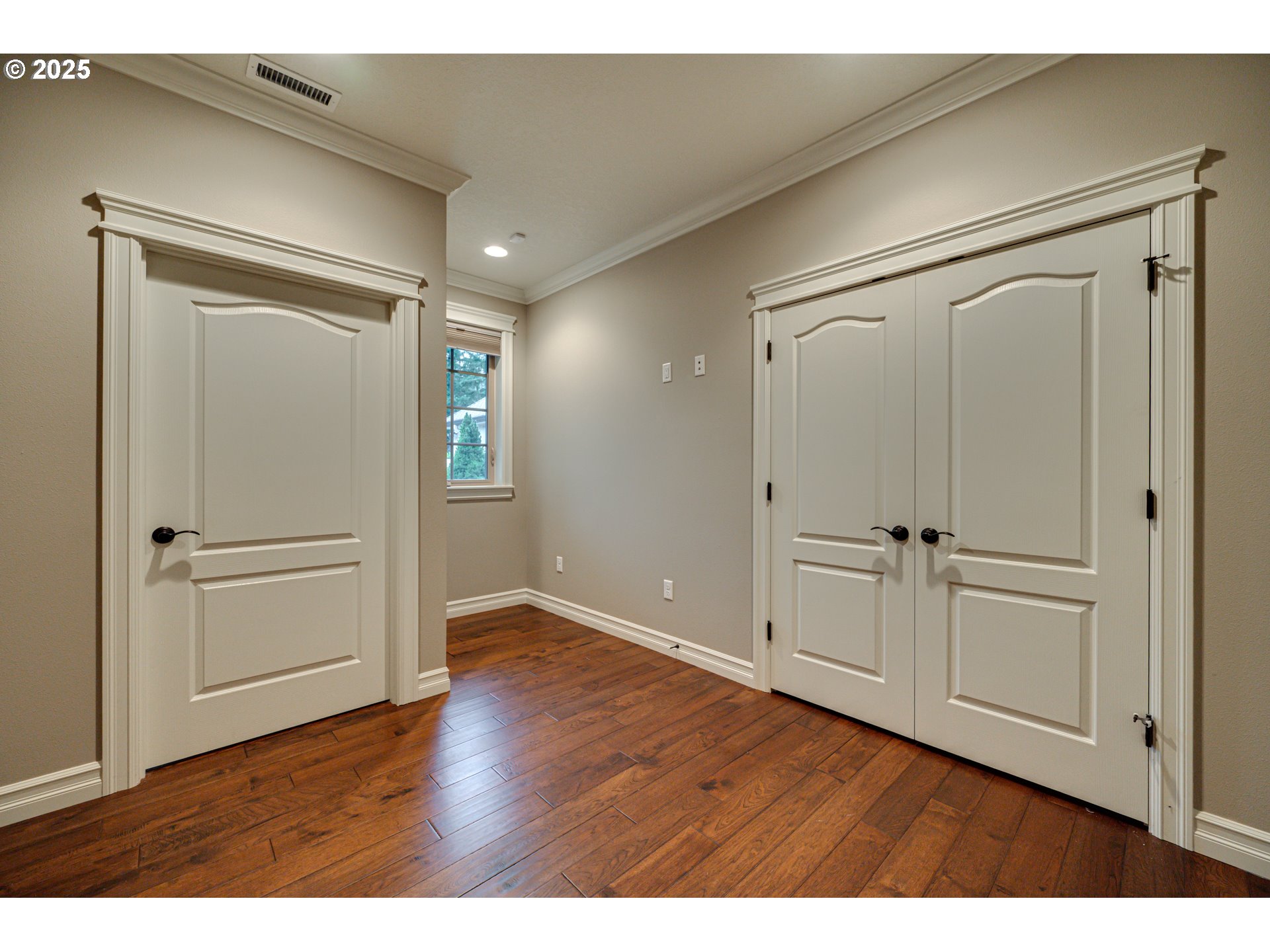 421 Woodland Heights Road Woodland, WA 98674 - Photo 23 of 48 a view of an empty room with wooden floor