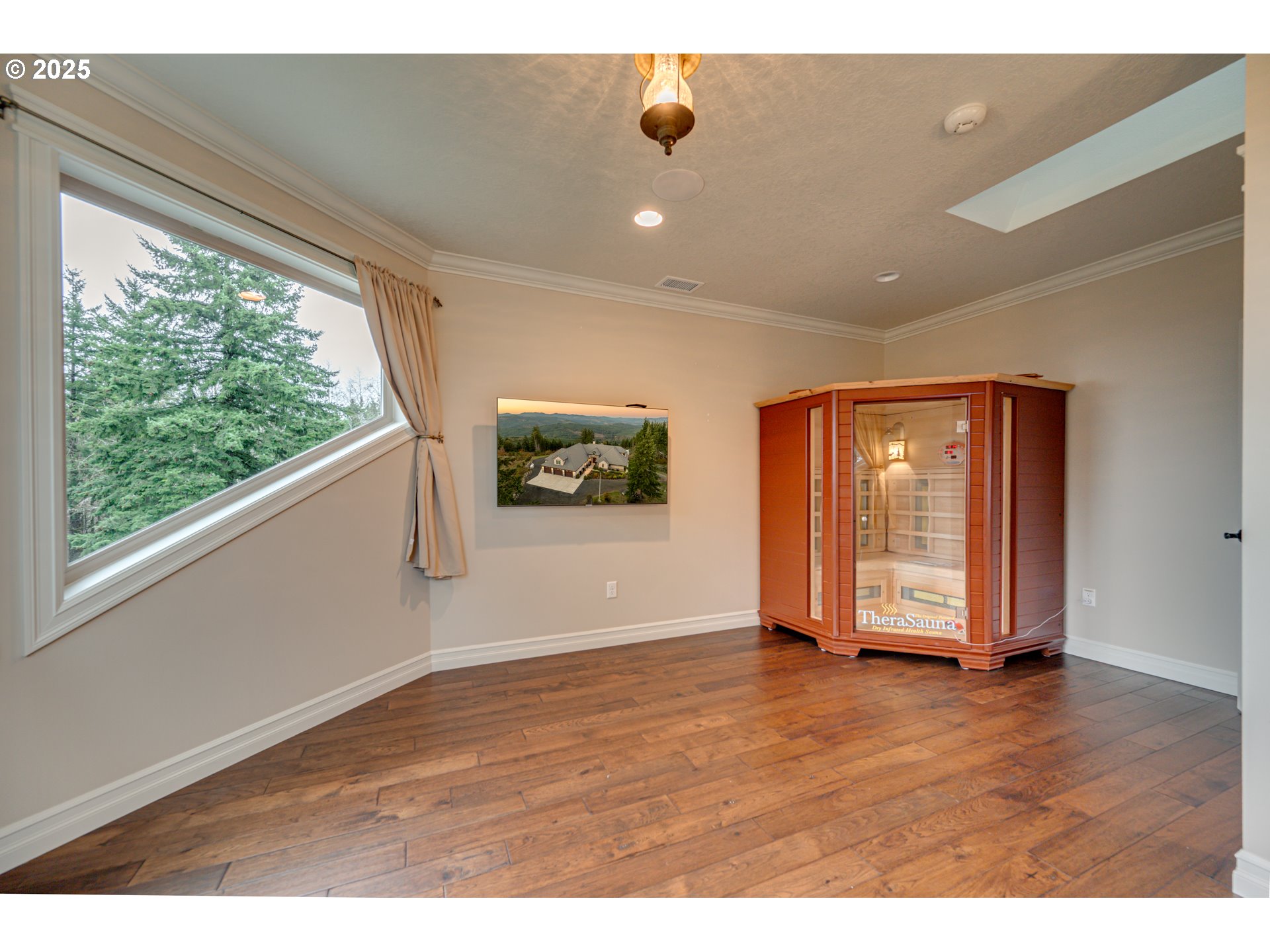 421 Woodland Heights Road Woodland, WA 98674 - Photo 25 of 48 a view of an empty room with wooden floor and a window