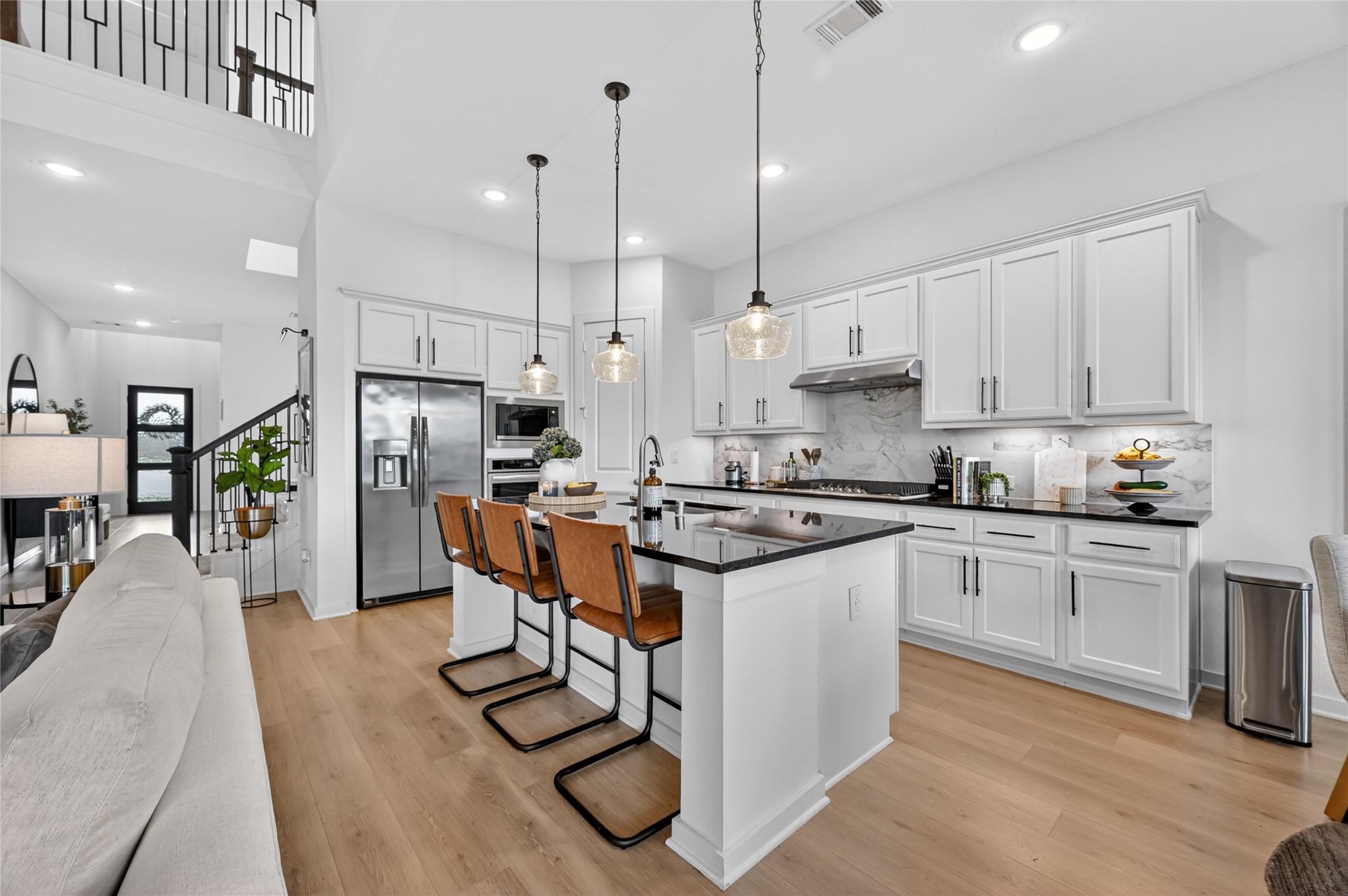 4439 Stone Ridge Lane Manvel, TX 77578 - Photo 13 of 48 a kitchen with stainless steel appliances kitchen island granite countertop a refrigerator a stove a sink and a center island