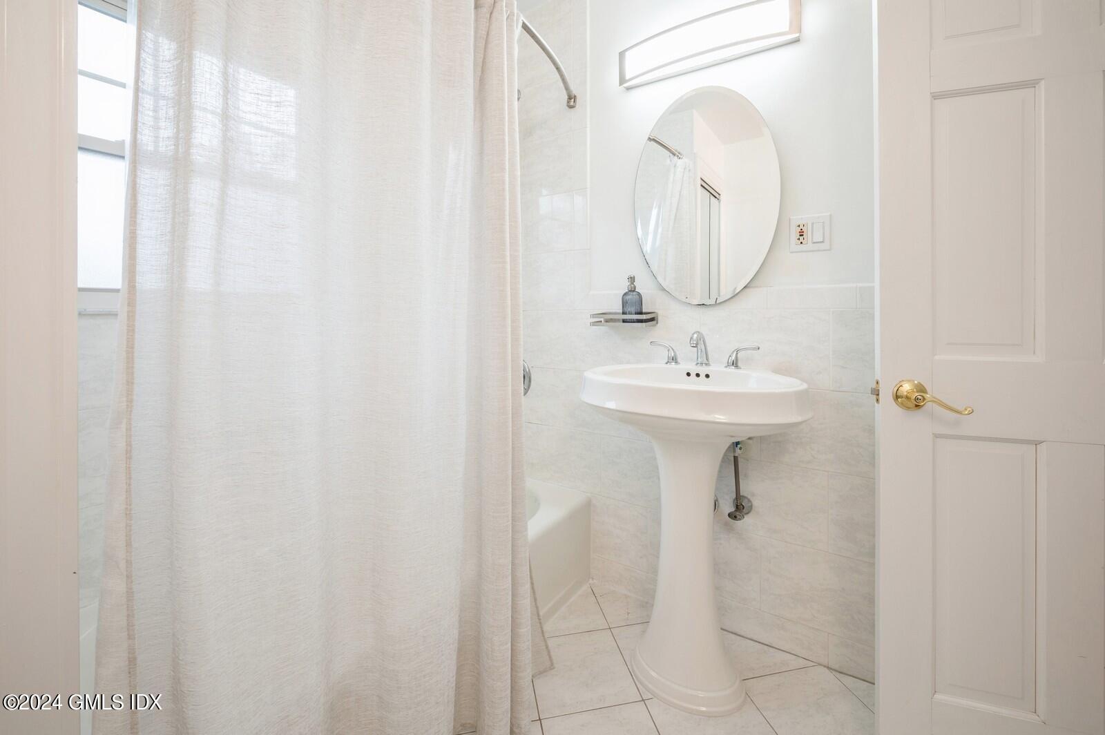 119 Halstead Avenue, Unit 2 Greenwich, CT 06831 - Photo 19 of 29 a bathroom with a sink a mirror and a shower