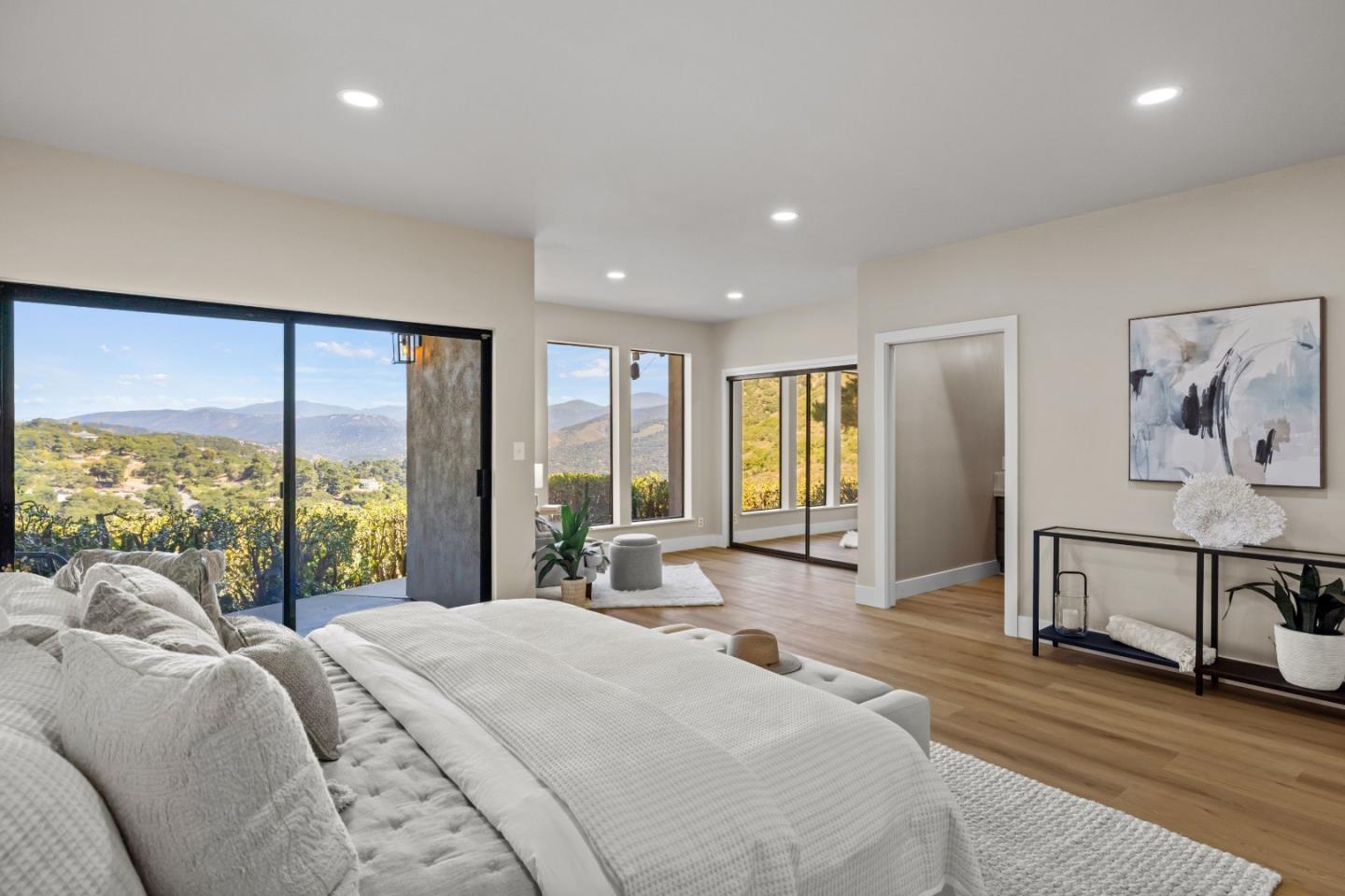 13399 Middle Canyon Road Carmel Valley, CA 93924 - Photo 18 of 32 a bedroom with a large bed and a large window