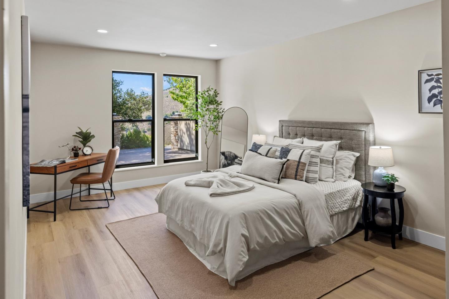 13399 Middle Canyon Road Carmel Valley, CA 93924 - Photo 21 of 32 a spacious bedroom with a bed and a large window