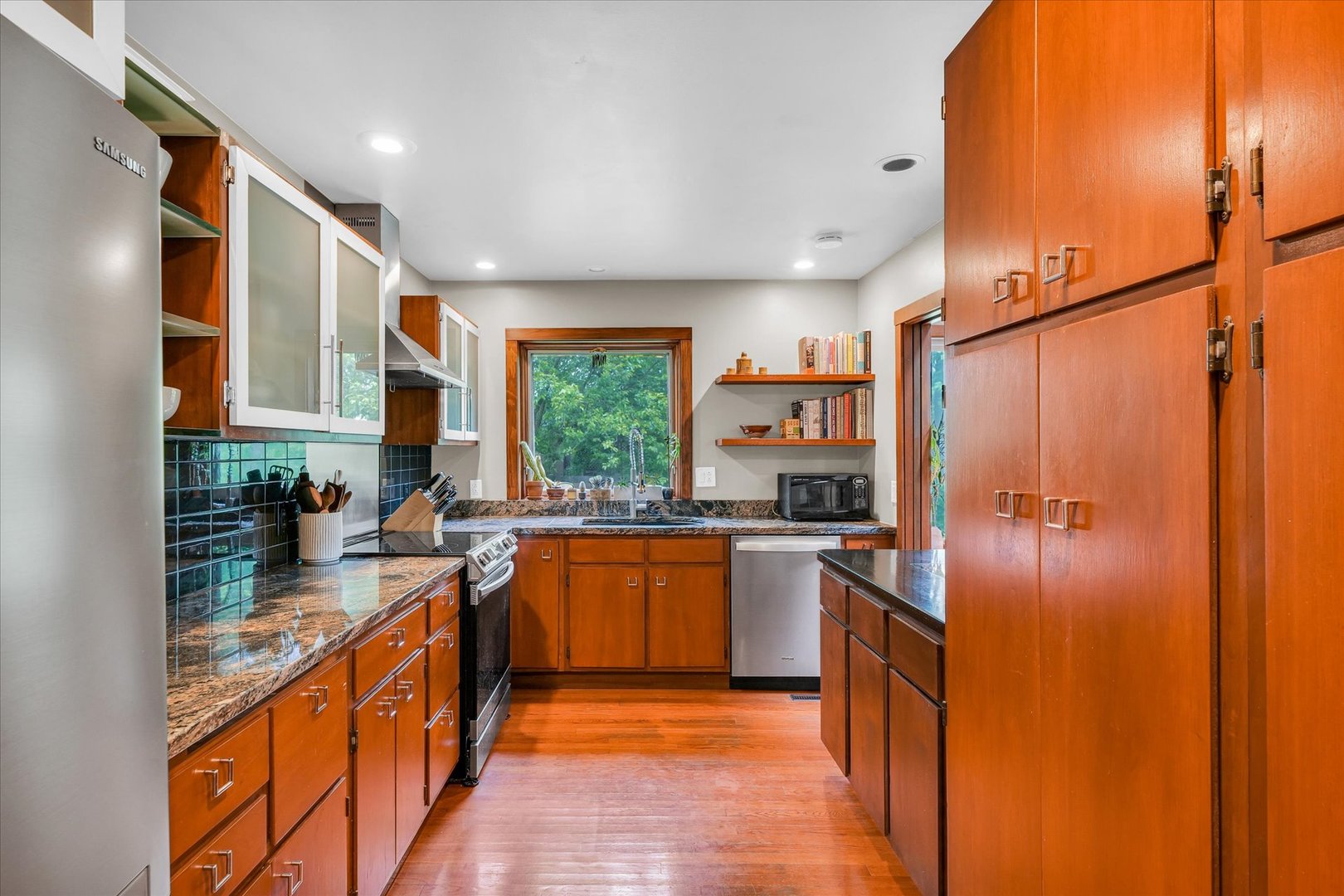 1910 Stratford Court Champaign, IL 61821 - Photo 16 of 39 a large kitchen with stainless steel appliances granite countertop a stove a sink and a refrigerator