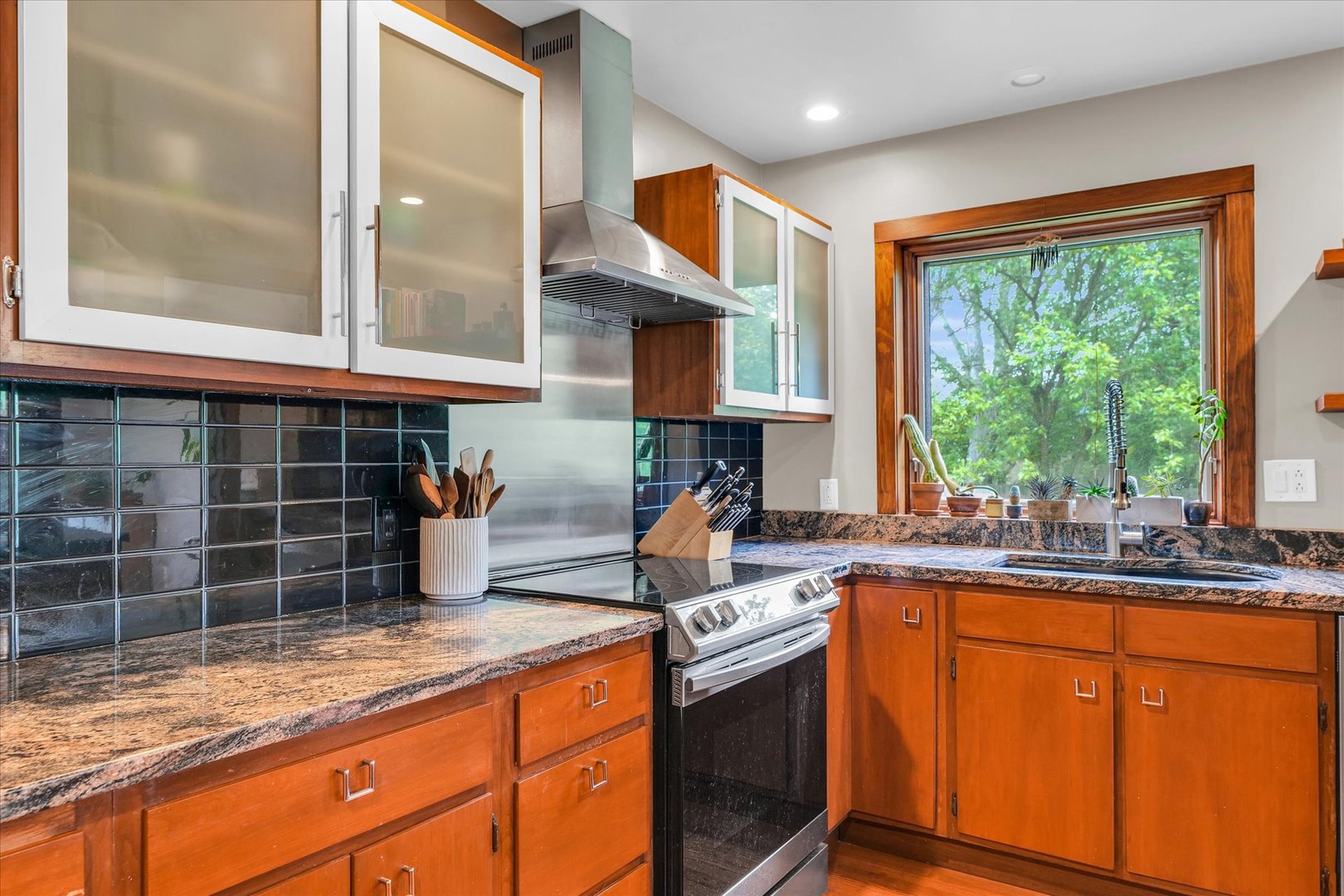 1910 Stratford Court Champaign, IL 61821 - Photo 17 of 39 a kitchen with granite countertop a sink and a window