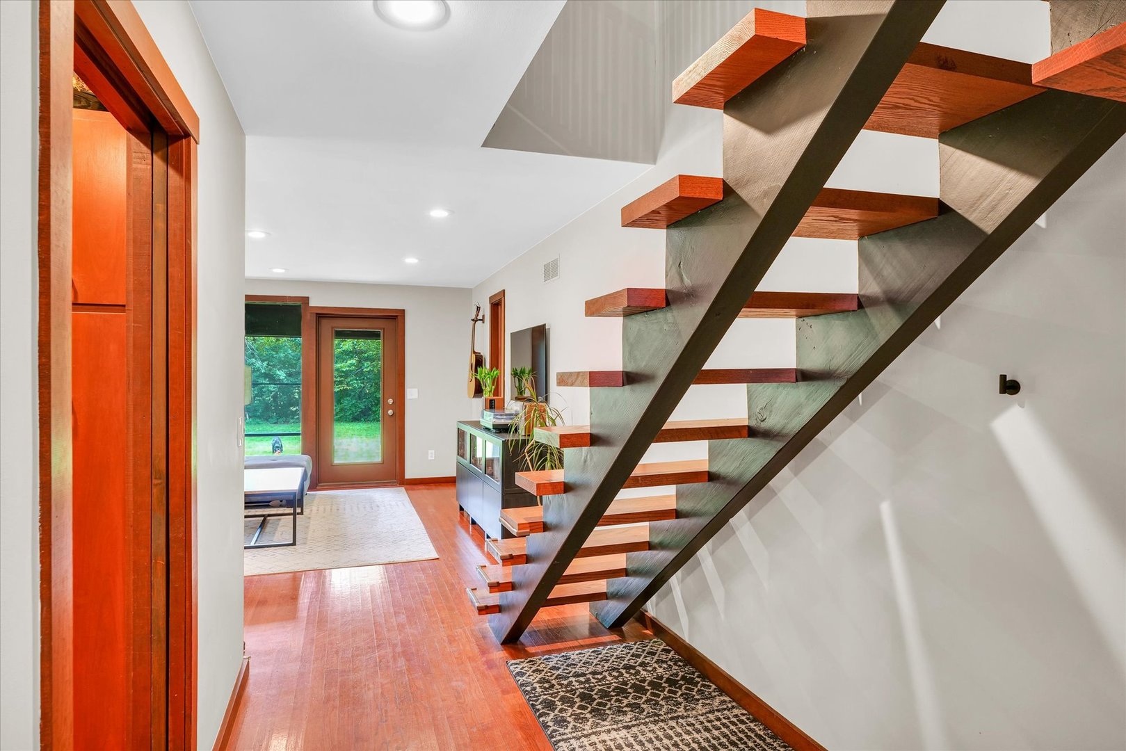 1910 Stratford Court Champaign, IL 61821 - Photo 5 of 39 a view of an entryway with wooden floor and stairs
