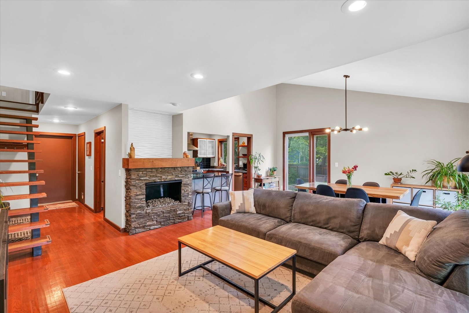1910 Stratford Court Champaign, IL 61821 - Photo 8 of 39 a living room with furniture a fireplace and a flat screen tv
