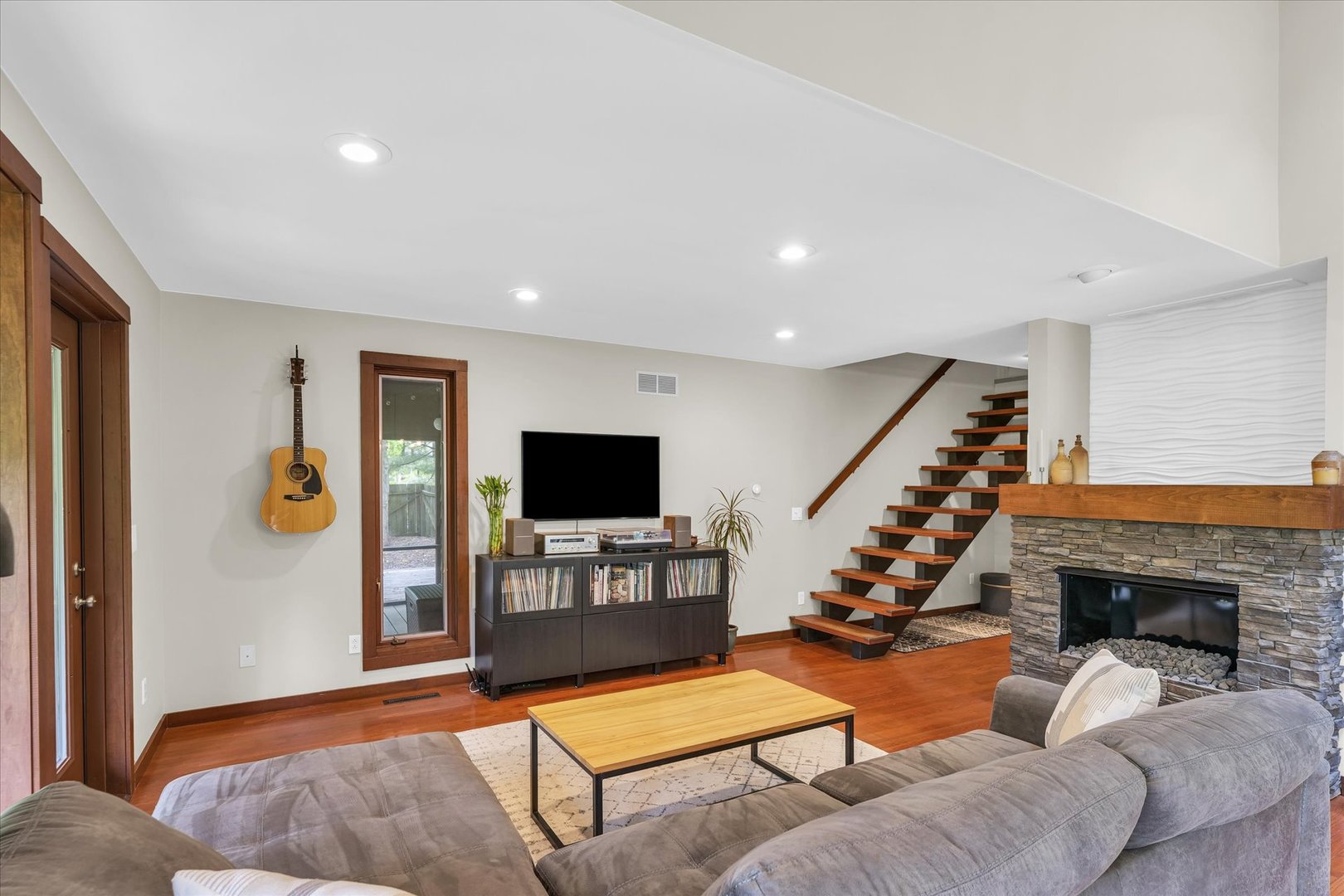 1910 Stratford Court Champaign, IL 61821 - Photo 10 of 39 a living room with furniture a fireplace and a flat screen tv