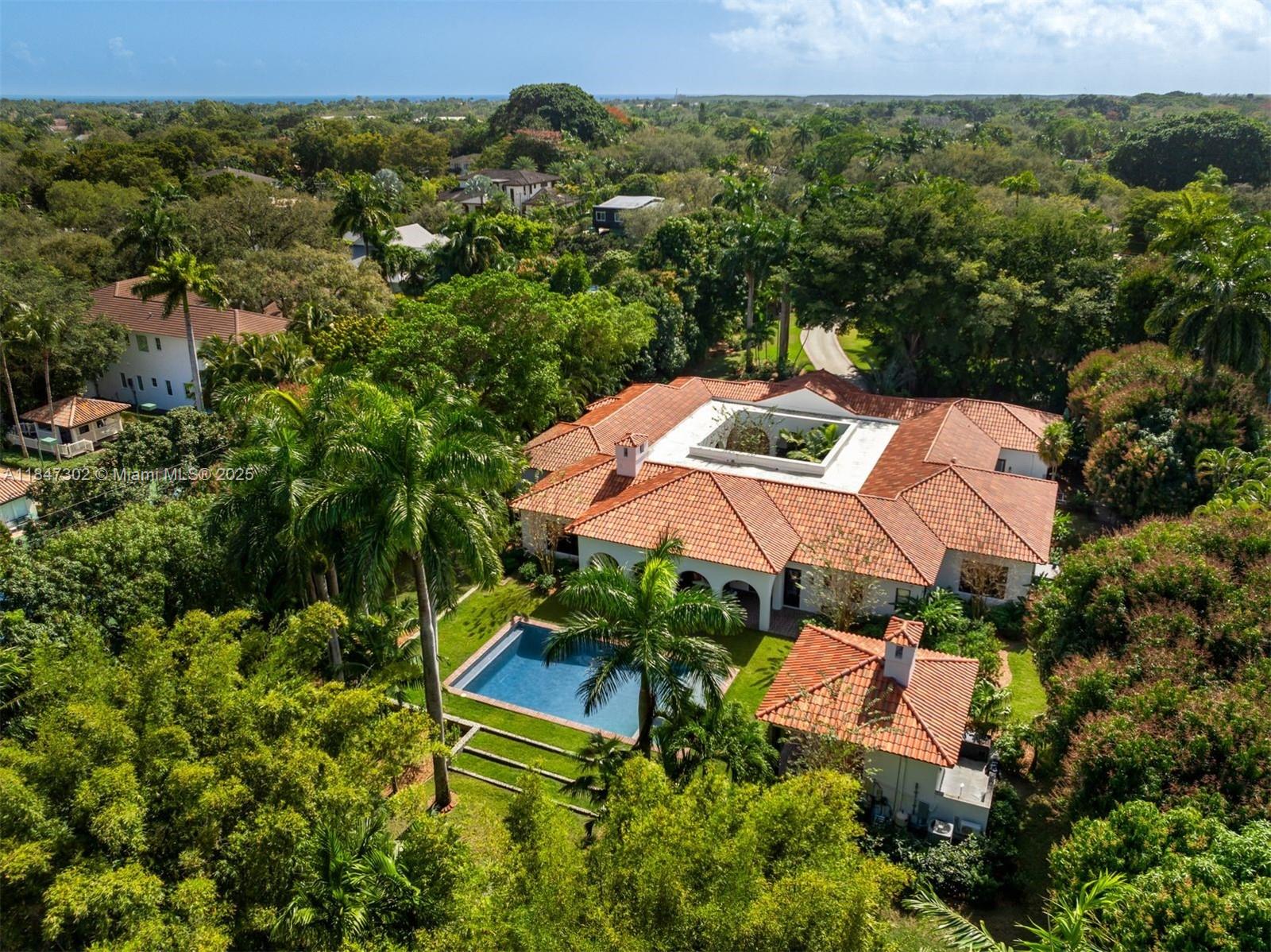 an aerial view of a house with yard swimming pool and outdoor seating