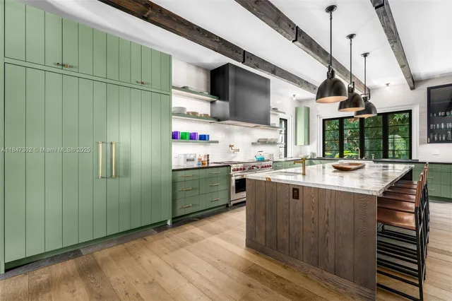 a kitchen with stainless steel appliances granite countertop a sink and cabinets