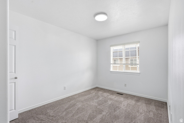 793 North 150 E Street Springville, UT 84663 - Photo 15 of 26 Room featuring a window with blinds, a flush mount ceiling light fixture, neutral gray carpet, and white trim