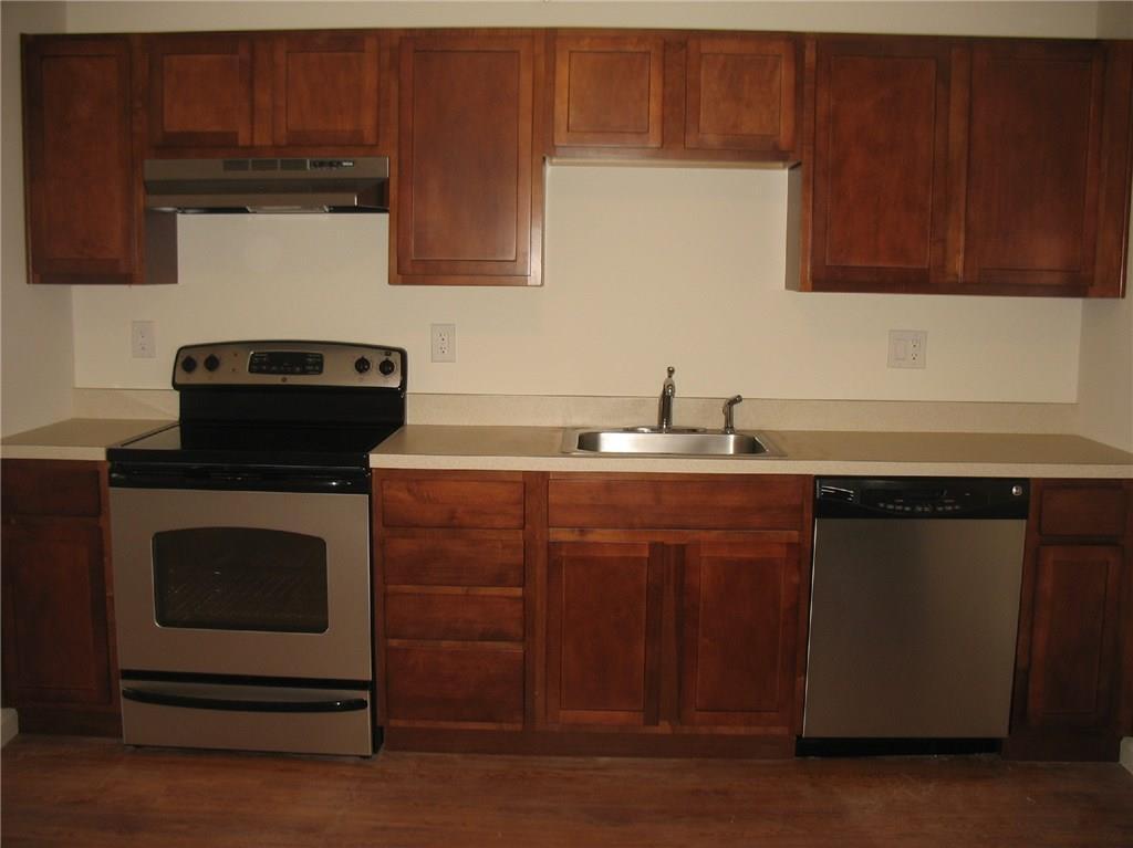 7 New Street, Unit 202 Danbury, CT 06810 - Photo 1 of 10 a kitchen with stainless steel appliances a stove a microwave and cabinets