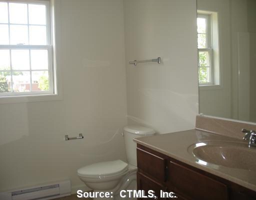 7 New Street, Unit 202 Danbury, CT 06810 - Photo 3 of 10 a bathroom with a sink a toilet and a window