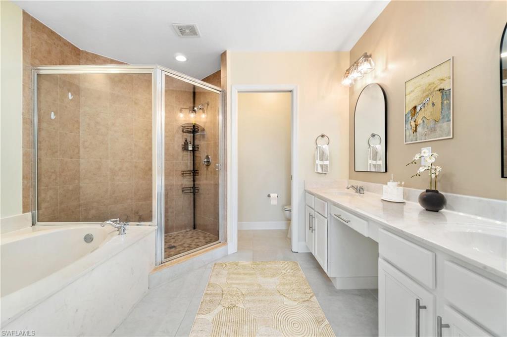 17560 Cherry Ridge Lane Fort Myers, FL 33967 - Photo 18 of 30 a spacious bathroom with a granite countertop sink mirror and shower