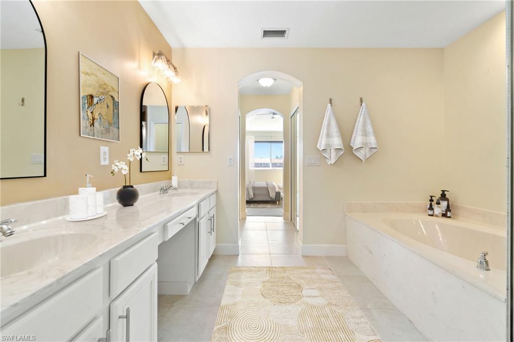 17560 Cherry Ridge Lane Fort Myers, FL 33967 - Photo 19 of 30 a spacious bathroom with a double vanity sink mirror and bathtub