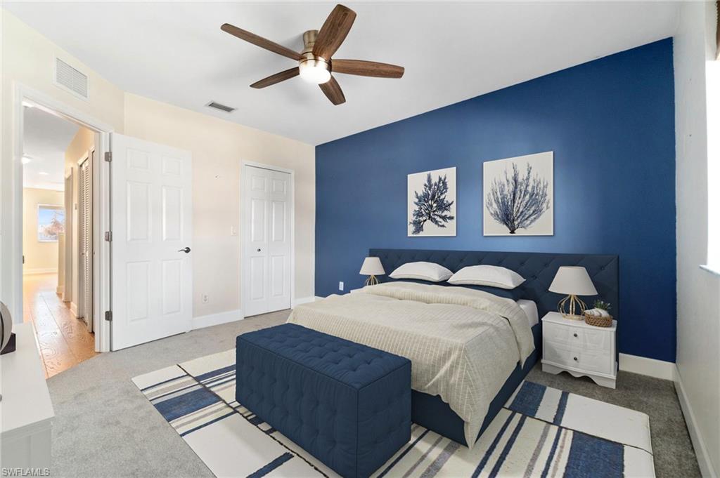 17560 Cherry Ridge Lane Fort Myers, FL 33967 - Photo 21 of 30 a bedroom with a bed and a chandelier