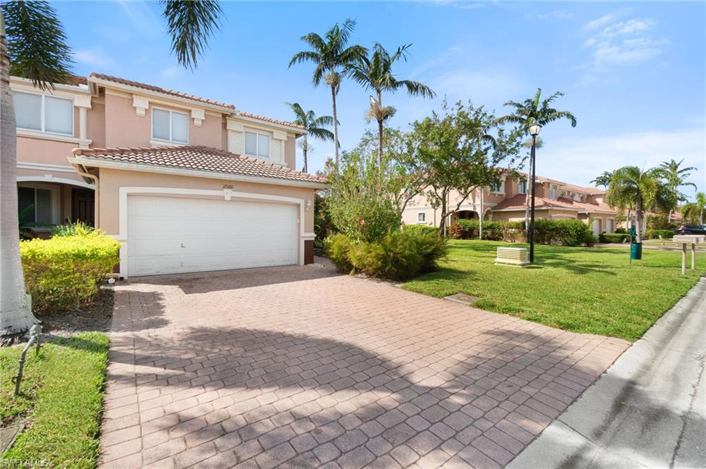 17560 Cherry Ridge Lane Fort Myers, FL 33967 - Photo 3 of 30 a front view of a house with a yard and a garage