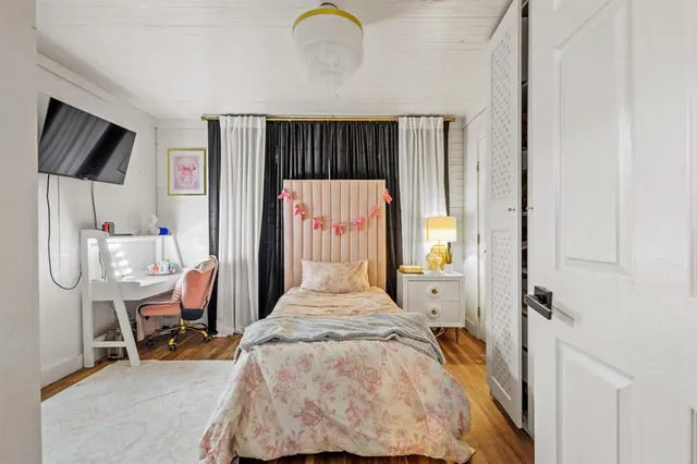 a bed room with a bed window and chair