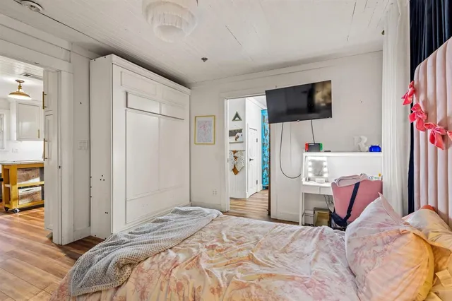 a bedroom with a bed and a flat screen tv