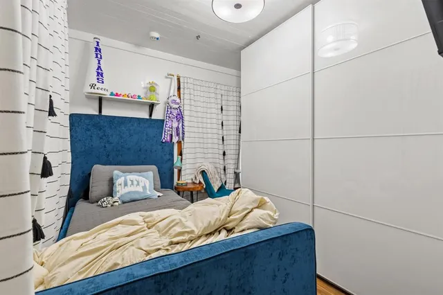 a bedroom with a bed and a window