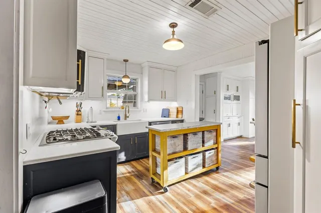 a kitchen with a sink cabinets and window