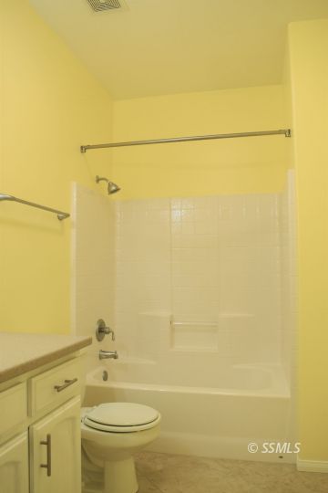 919 Sims Street Ridgecrest, CA 93555 - Photo 13 of 32 a bathroom with a toilet a sink and shower