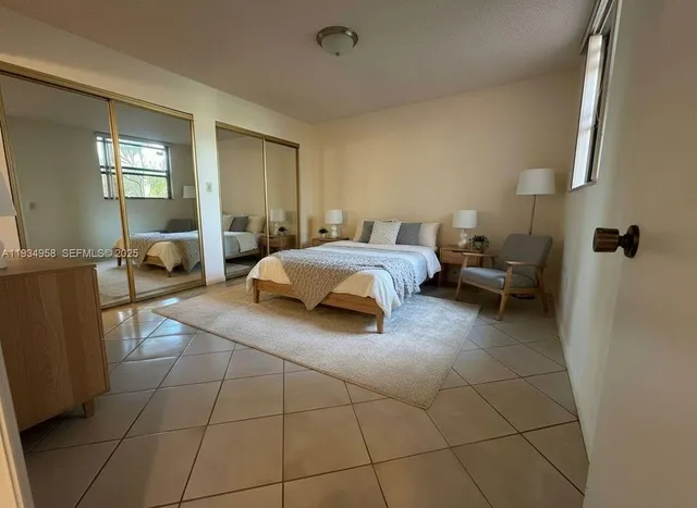 a spacious bedroom with a bed and window