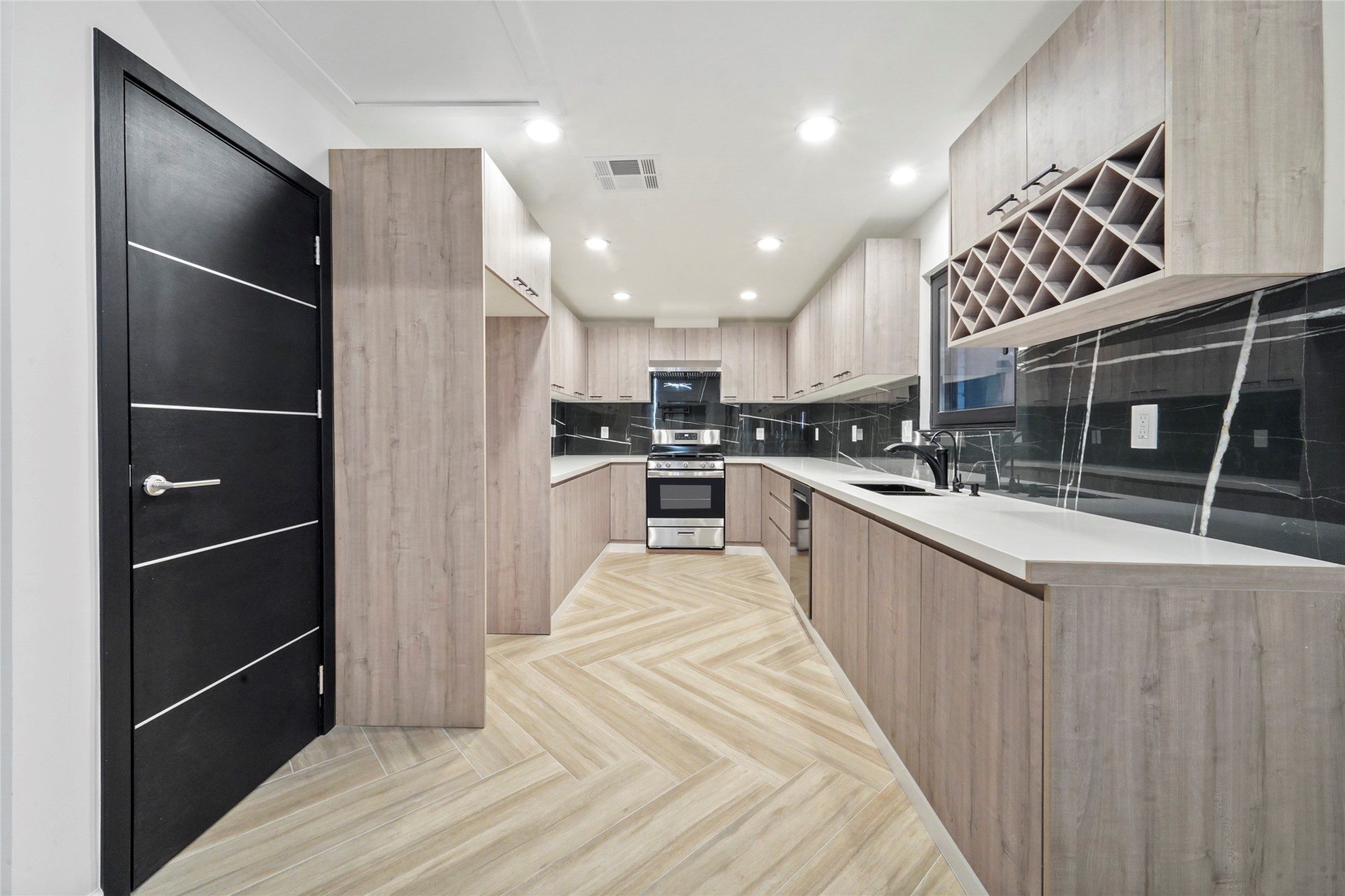 2438 Carriage Lamp Lane Conroe, TX 77384 - Photo 13 of 41 a large kitchen with stainless steel appliances kitchen island granite countertop a refrigerator and a sink
