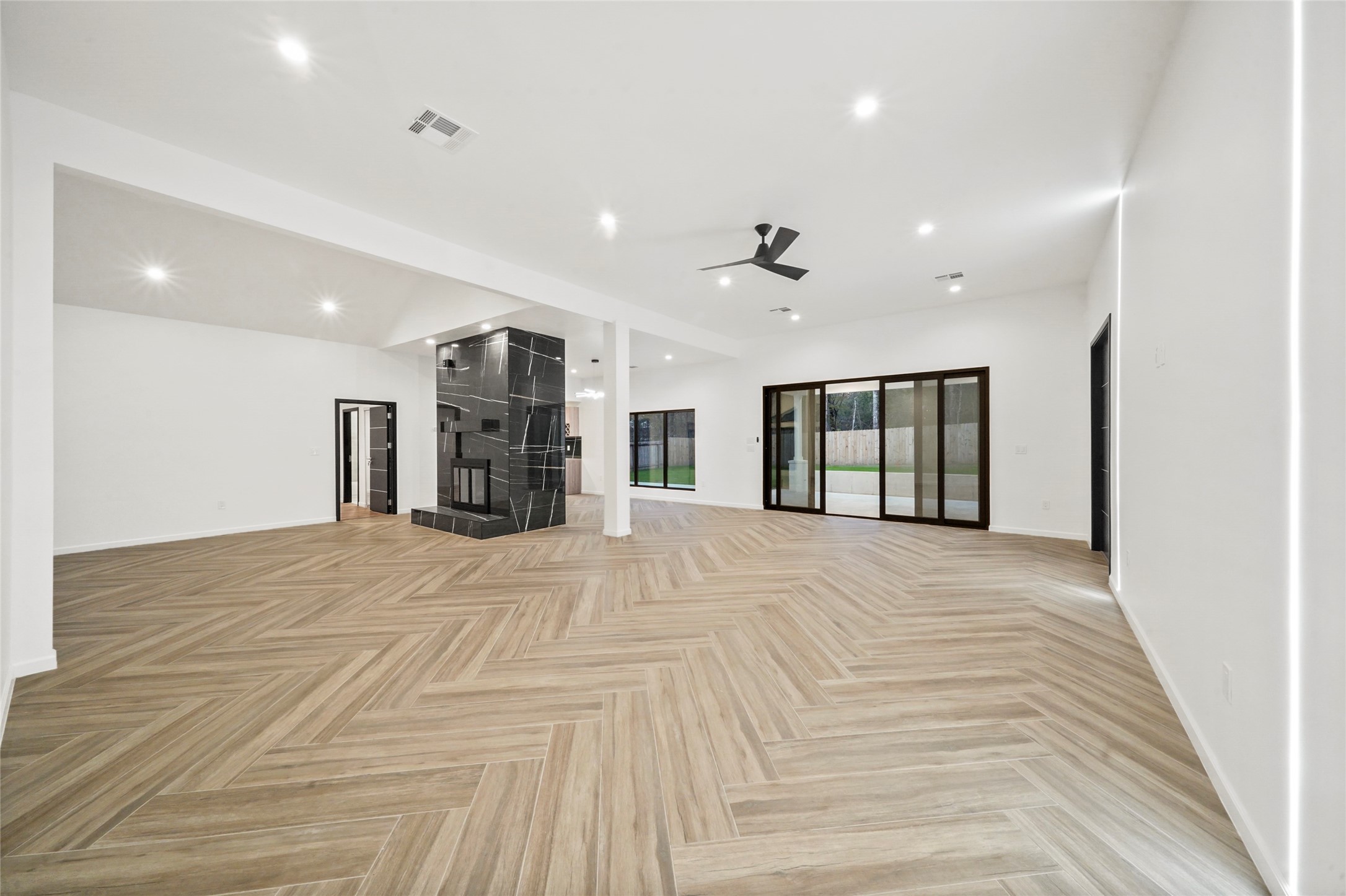 2438 Carriage Lamp Lane Conroe, TX 77384 - Photo 16 of 41 a view of an empty room with a fireplace and a window