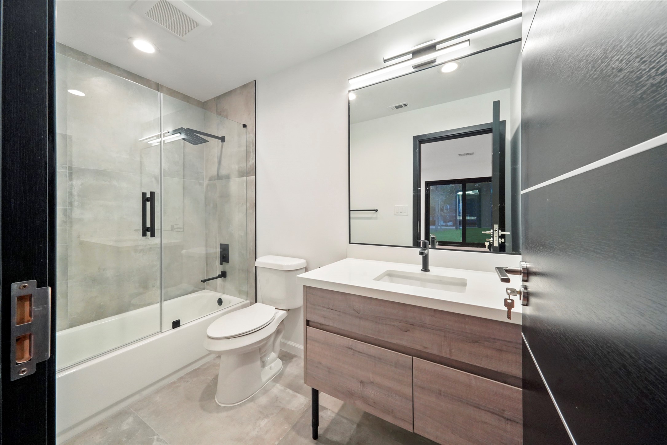 2438 Carriage Lamp Lane Conroe, TX 77384 - Photo 26 of 41 a bathroom with a sink a toilet and shower