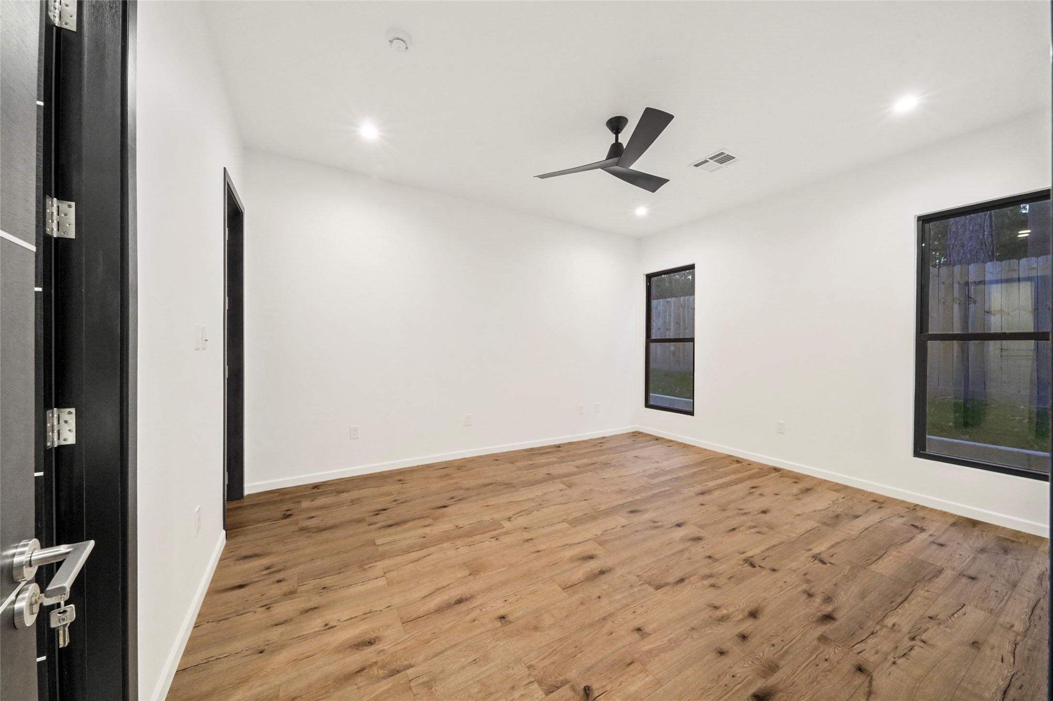 2438 Carriage Lamp Lane Conroe, TX 77384 - Photo 27 of 41 a view of empty room with wooden floor and fan