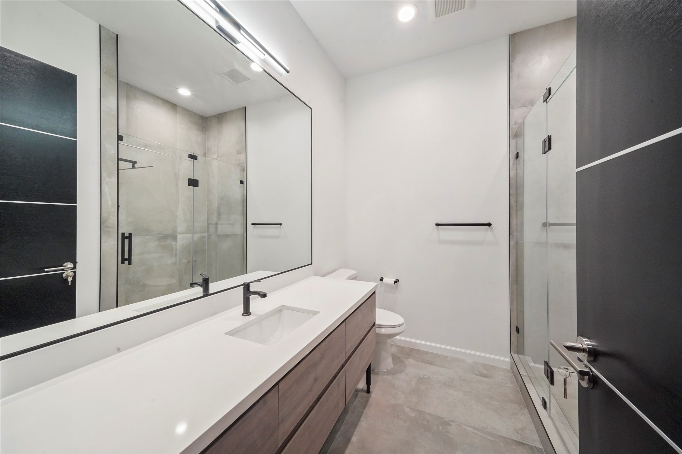 2438 Carriage Lamp Lane Conroe, TX 77384 - Photo 28 of 41 a bathroom with a sink and a large mirror