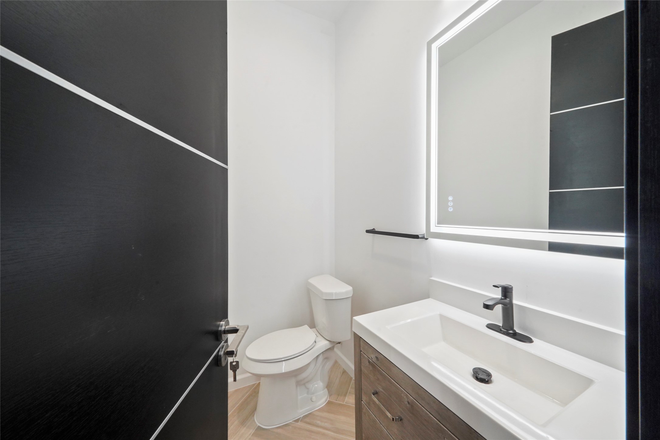 2438 Carriage Lamp Lane Conroe, TX 77384 - Photo 30 of 41 a bathroom with a sink a toilet and mirror