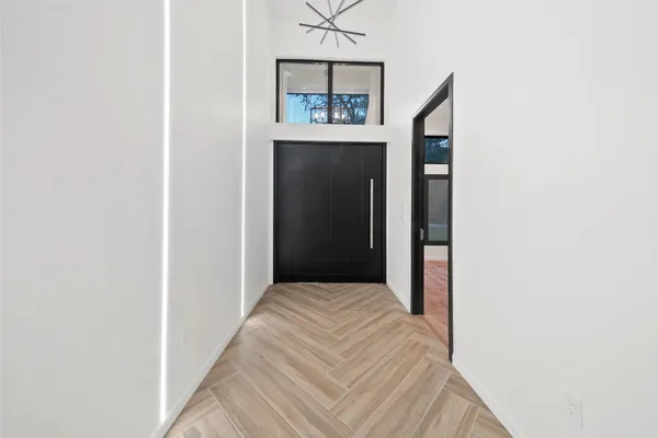 a view of a hallway to rooms and stairs