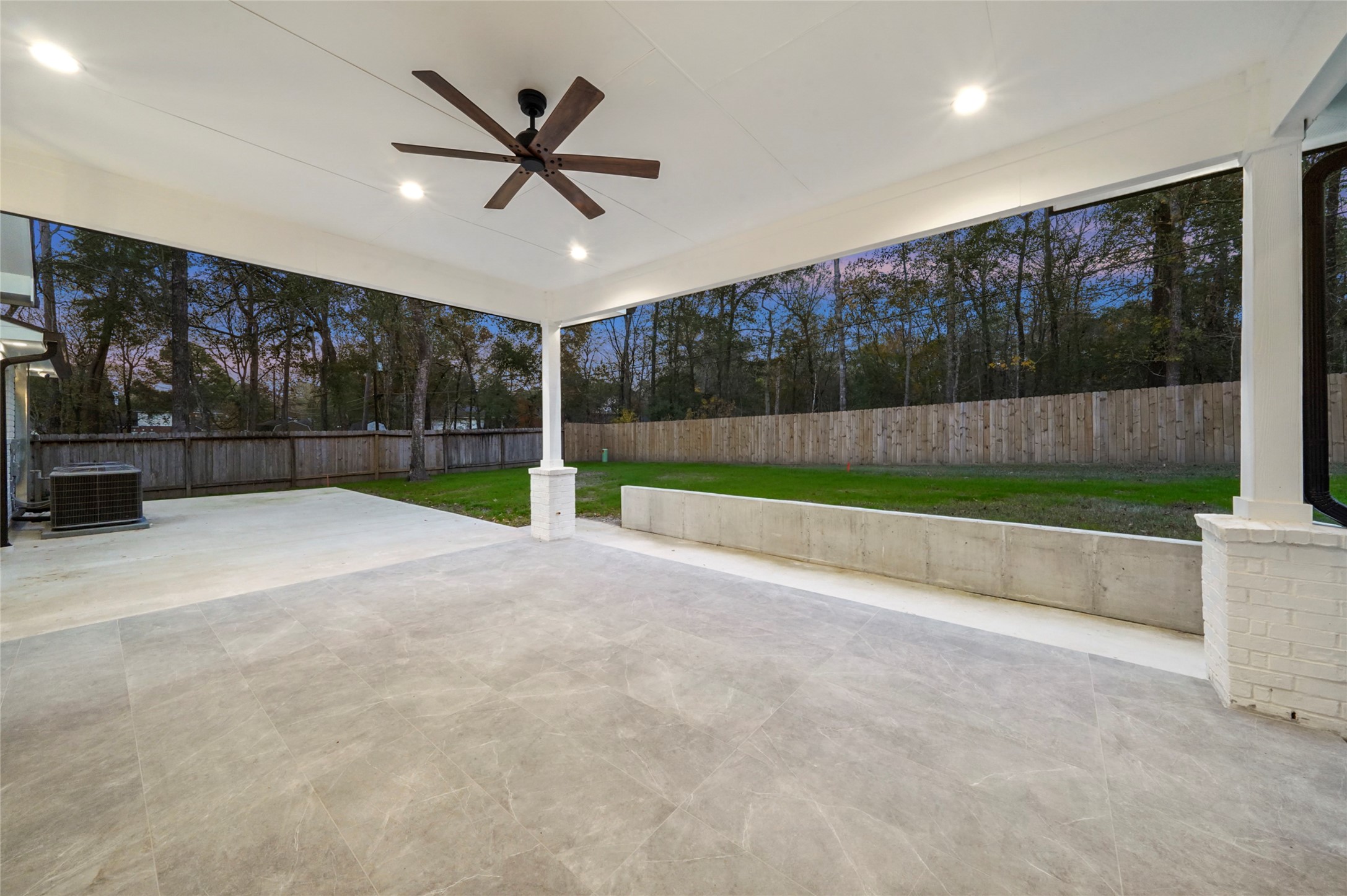 2438 Carriage Lamp Lane Conroe, TX 77384 - Photo 35 of 41 a view of a livingroom with a ceiling fan and kitchen view