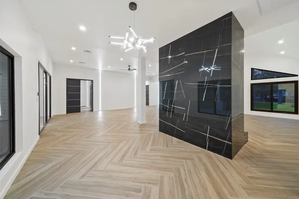 a view of a hallway with wooden floor and door