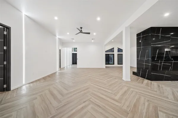 a view of empty room with wooden floor