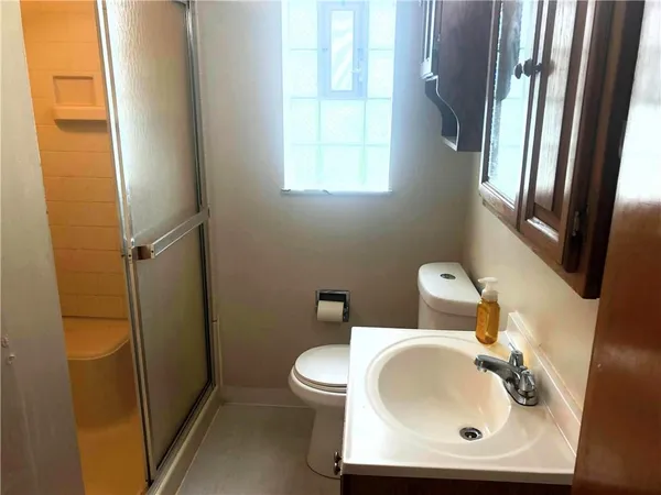 a bathroom with a sink a toilet and a mirror