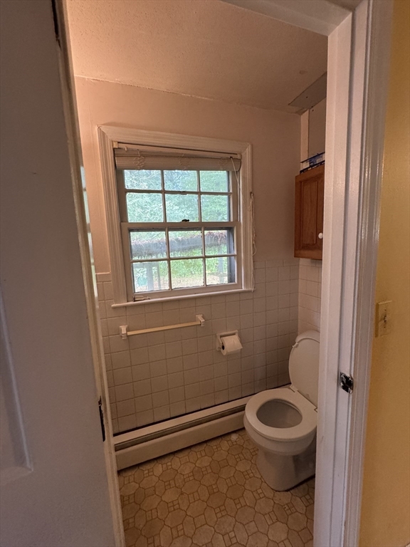 9 Edgewood Avenue Merrimack, NH 03054 - Photo 7 of 13 a bathroom with a toilet a sink and window