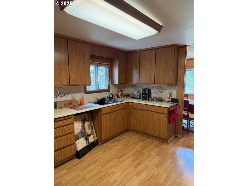 64294 Penny Road Coos Bay, OR 97420 - Photo 11 of 26 a kitchen with a sink cabinets and window