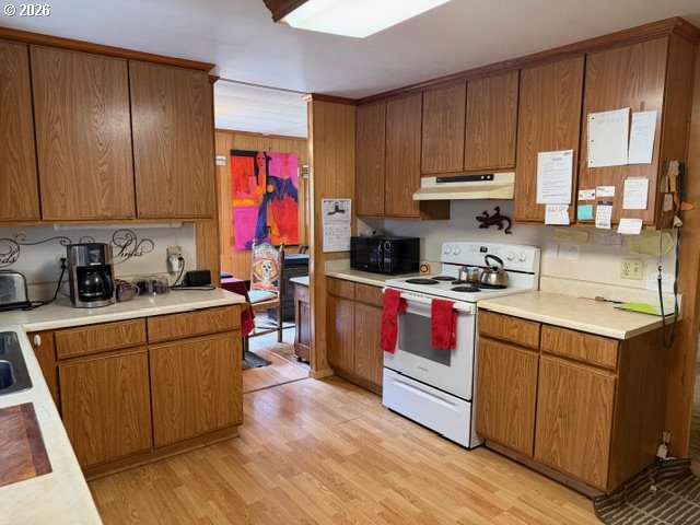 64294 Penny Road Coos Bay, OR 97420 - Photo 12 of 26 a kitchen with kitchen island granite countertop wooden cabinets stainless steel appliances and a window