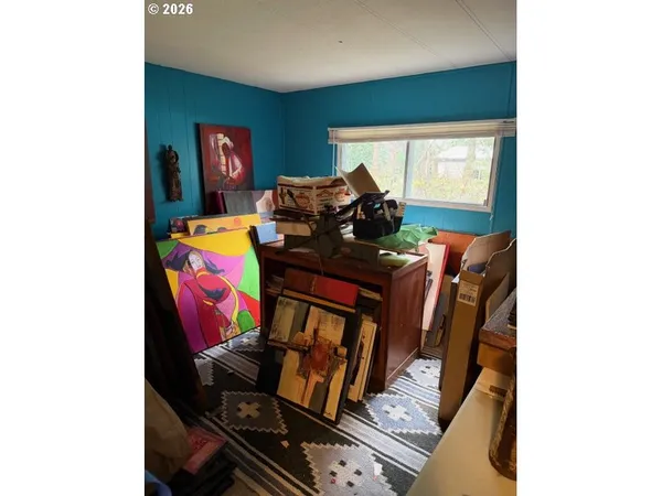 a bedroom with a bed and a mirror