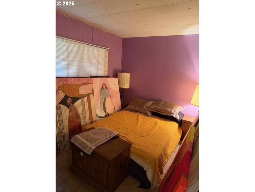 64294 Penny Road Coos Bay, OR 97420 - Photo 15 of 26 a bedroom with a bed and a mirror