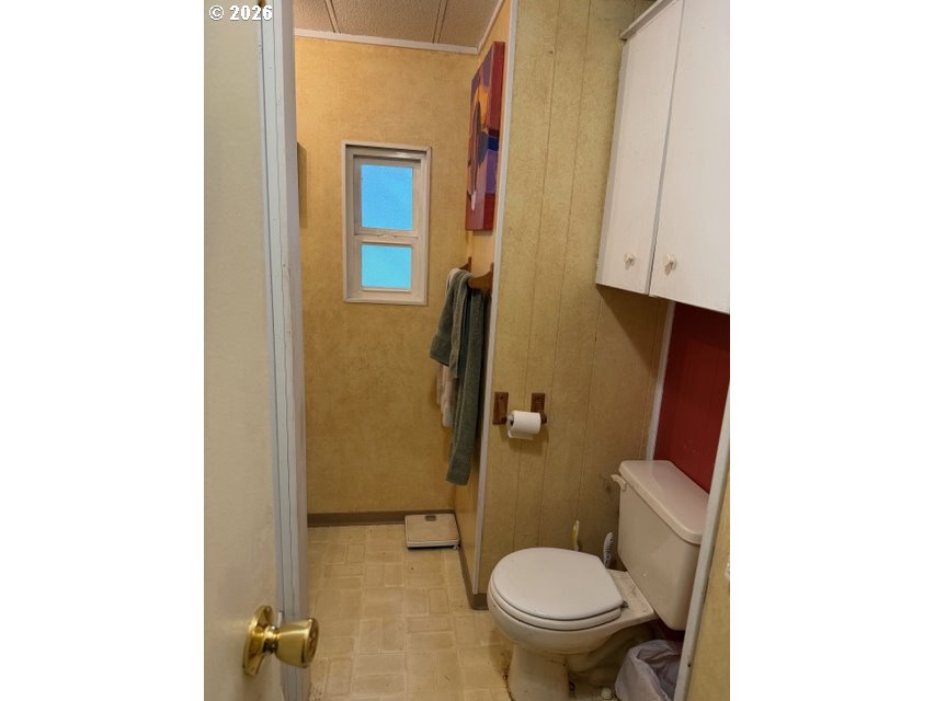 64294 Penny Road Coos Bay, OR 97420 - Photo 16 of 26 a white toilet sitting next to a bathroom sink