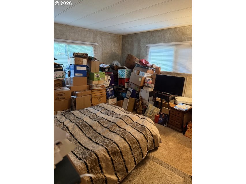 64294 Penny Road Coos Bay, OR 97420 - Photo 18 of 26 a bed room with a bed and a desk